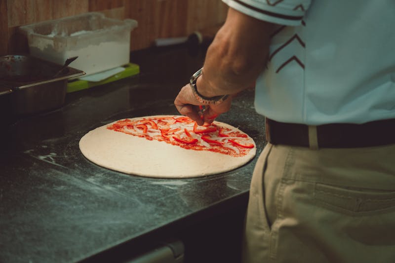Via 313 restaurant interior with Detroit-style pizza being prepared
